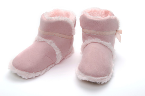 Womens indoor pink fur lined soft leather slippers - studio shot with a white background