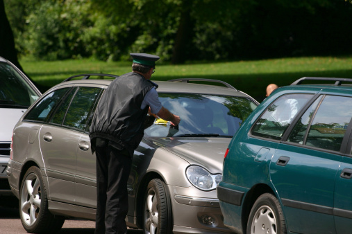 automobile parked receiving a ticket in England
