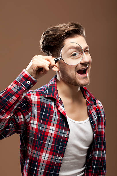 istock Portrait of a man with magnifying glass 184953616
