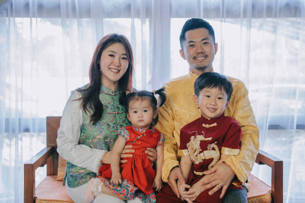 Asian chinese young family photo celebrating chinese new year looking at camera for best wishes, luck , prosperity and health Asian chinese young family photo celebrating chinese new year looking at camera for best wishes, luck , prosperity and health chinse baby stock pictures, royalty-free photos & images