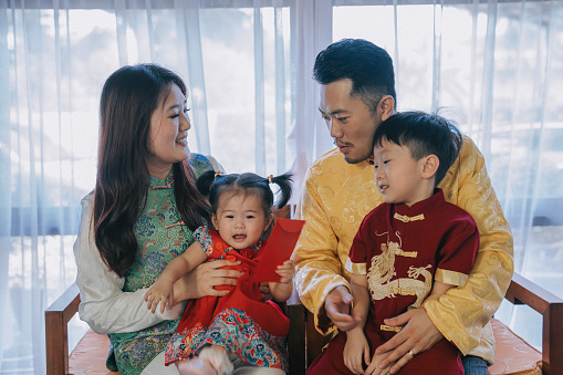 Asian chinese family photo celebrating chinese new year looking at camera for best wishes, luck , prosperity and health