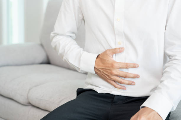istock stomach ache. men have abdominal pain, indigestion, gastritis, flatulence, diarrhea, distention, colon cancer, belly inflammation problem, suffer food poisoning, abdomen, acid reflux 1849540586