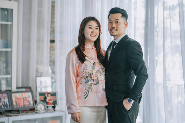Asian Chinese couple portrait looking at camera smiling