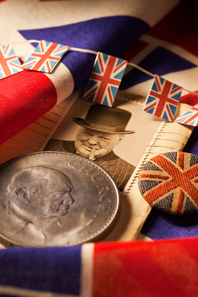 Britains Greatest Briton Winston Churchill Voted Britain’s greatest Briton of all time, Sir Winston Spencer Churchill. Very few great people make it to a UK postage stamp, but to be immortalised on a coin of the realm too, is rare indeed. Sir Winston Churchill was born in 1874 and died in January 1965 achieving his finest hours as a politician and leader of Britain during World War II. Following the resignation of Neville Chamberlain in May 1940, Churchill became the Prime Minister. Here he is immortalised on a stamp with his trademark Homburg hat and smoking a Havanna cigar, along with a special minted coin, a Crown, a coin in use prior to decimalisation in February 1971. british flag photos stock pictures, royalty-free photos & images