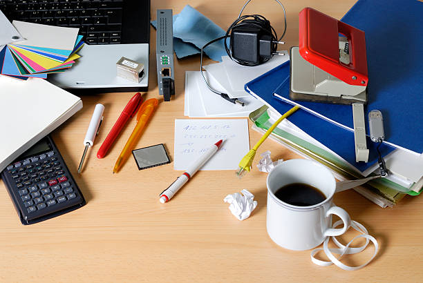 messy desktop messy office desk.business / office hole puncher stock pictures, royalty-free photos & images