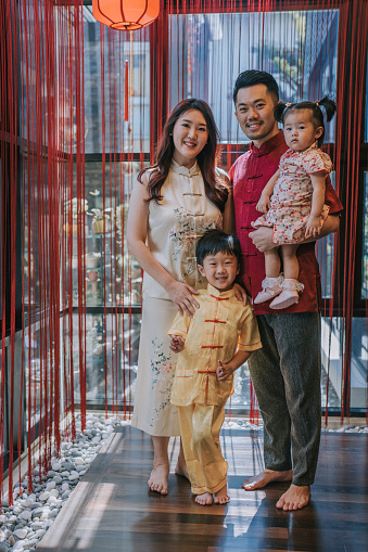 Asian chinese young family photo celebrating chinese new year looking at camera for best wishes, luck , prosperity and health