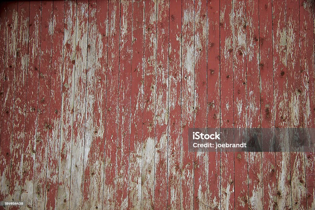 Aged Red Fence "Aged, peeling, red fence/barn door for textured or background wallpaper setting." Red Stock Photo