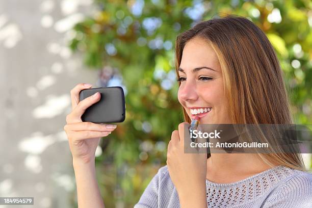 Mulher Bonita Fazendo Um Usando Um Telefone Inteligente Com Espelho - Fotografias de stock e mais imagens de Adolescente