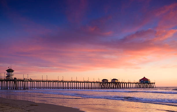 Sunset in Huntington Beach Sunset at the beach and view of the Huntington Beach Pier huntington beach california stock pictures, royalty-free photos & images