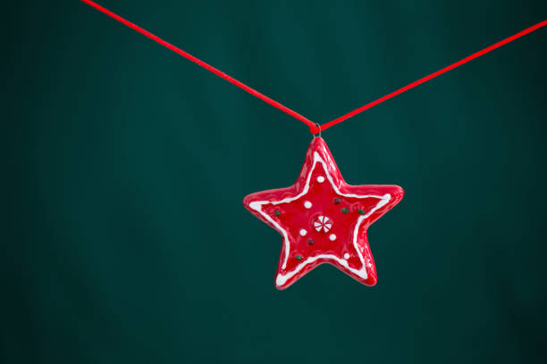 red christmas star on green background