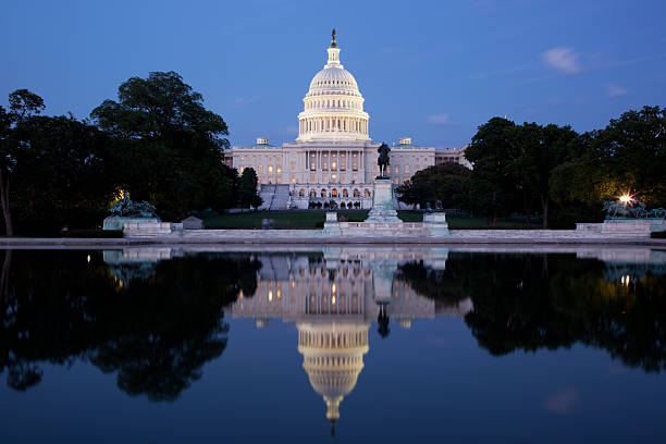 istock U S Capitol building lit up at dusk reflecting into pool 184955125