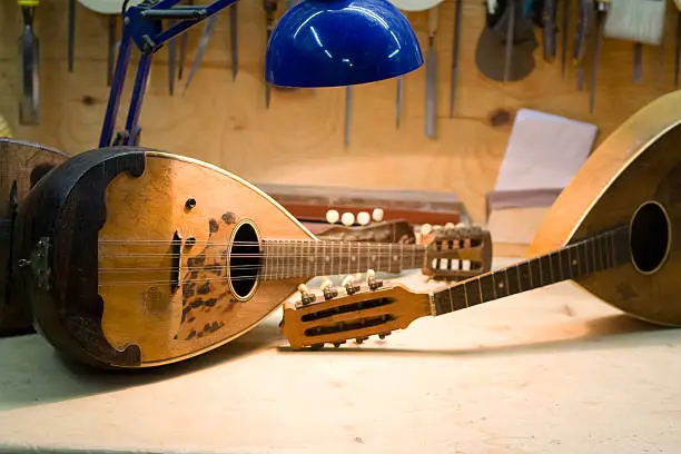 "Mandolin workshop with some mandolins dispayed and tools in the background. Naples, Italy."