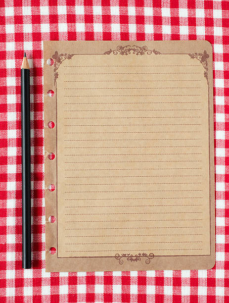 istock Pencil and old paper on red tableclot 184955395