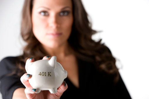 woman holding her 401K piggy bank