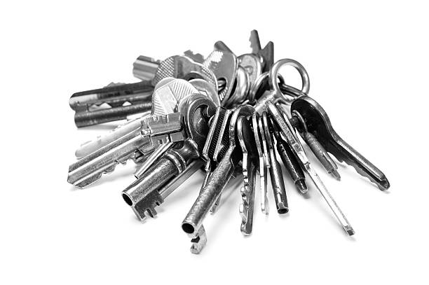 Old keys on key ring Key ring with a number of old keys of different types isolated on white. High contrast. key ring photos stock pictures, royalty-free photos & images