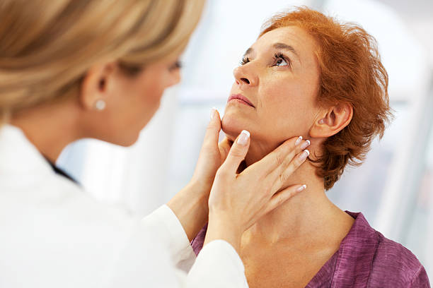 Female doctor examining her patient. Close-up of a female doctor doing a medical examination. The focus is on the mature adult woman being examined.    ent stock pictures, royalty-free photos & images