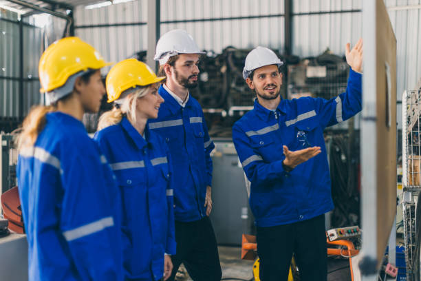 istock Engineer team employee plan meeting. Plant staff worker safety technician group planning process discussion with white board present workflow. 1849568003