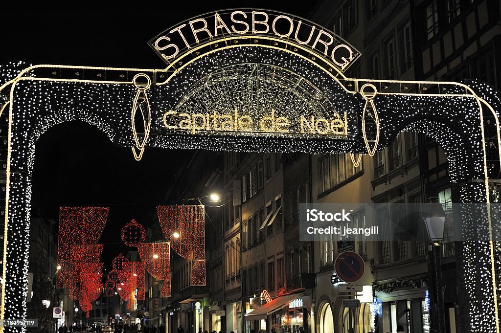 Strasbourg, Christmas Capital "**Shop signs have been removed or changed apart from the letters TABA which are part of the generic French sign TABAC, meaning Tobacconist shop** Sign in Christmas lights saying Strasbourg, Christmas capital, at the start of amain shopping street downtown in Strasbourg, France. During December, Strasbourg has six large Christmas markets every day as well as special events and the whole city has special Christmas lighting on many private and public buildings.More like this" Strasbourg Stock Photo
