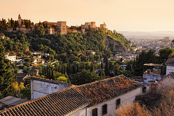 View on Alhambra at sunset "View on Alhambra Alhambra, Granada, Spain at sunset. The City of Granada can be seen in the background.Please see some more Alhambra pictures from my portfolio:" granada stock pictures, royalty-free photos & images
