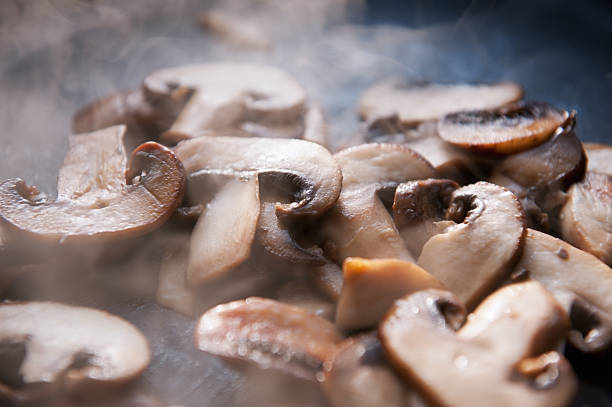 istock sliced field mushrooms cooking in steaming open pan 184957489