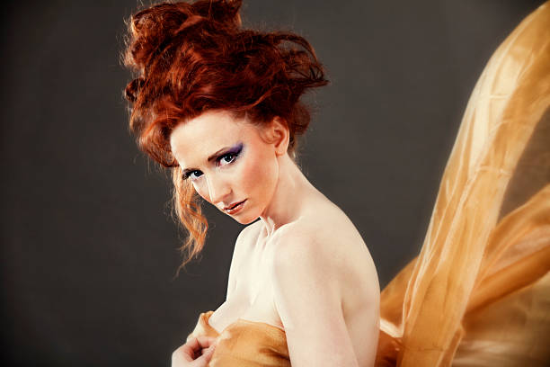 istock High fashion: elegant model with golden scarves 184957609