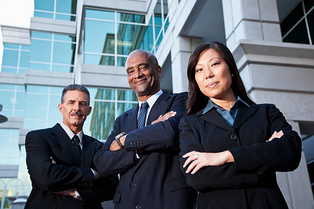 istock Businesspeople standing outside office building 184957940