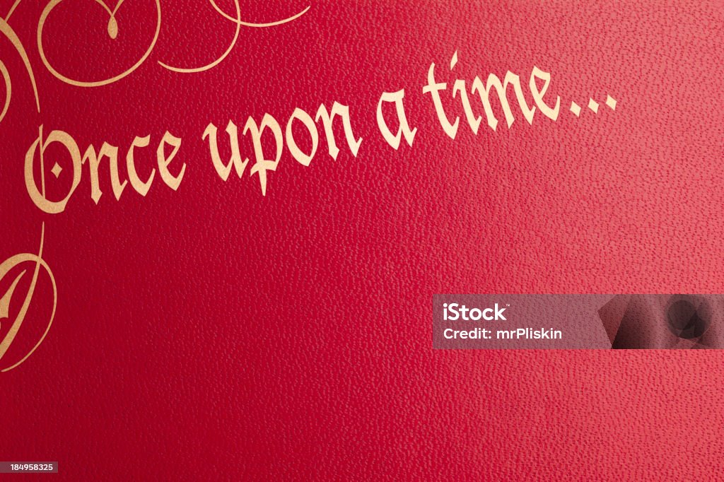 Once upon a time red leather book cover The phrase 'Once upon a time...' with embellishments in gold on a red leather book cover. Picture Book Stock Photo