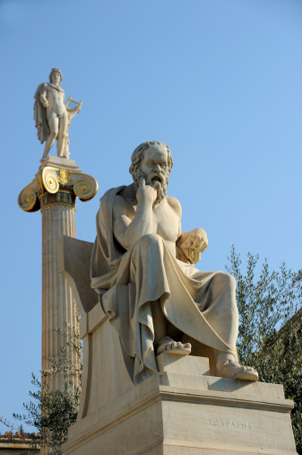 The statue of ancient greek philosopher Socrates in the forecourt of Athens Academy building. At the back the statue of Apollo.The sculptural decoration of the building was executed between 1870 -1880.related images