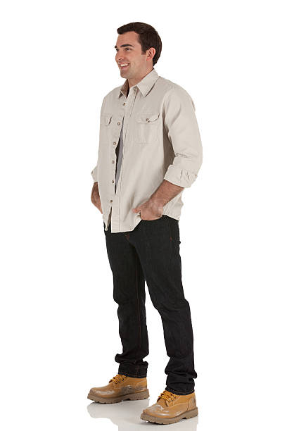 Happy man standing with his hands in pockets
