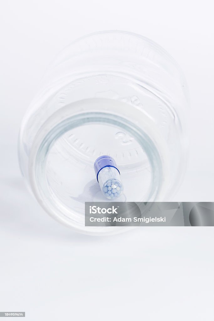 blue pill inside bottle group of nutritional supplement blue pills on white backgroundsee my Abundance Stock Photo