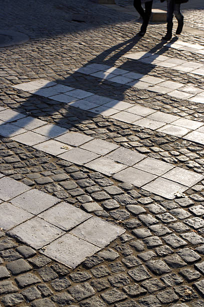 Two people cross the street stock photo