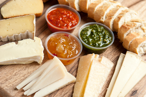 Assorted gourmet cheeses and chutneys close up