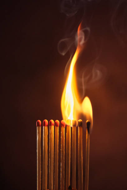 istock a row of matches are lit on a dark background 1849599025