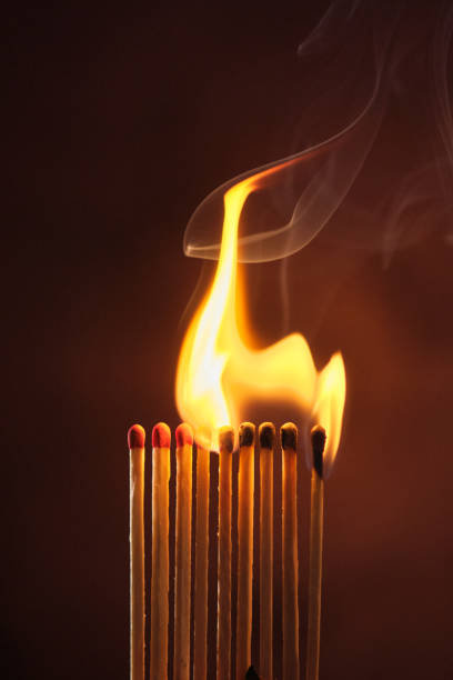 istock a row of matches are lit on a dark background 1849599320