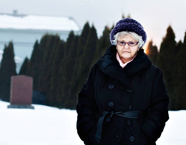 istock Senior lady walking in cemetery 184959991
