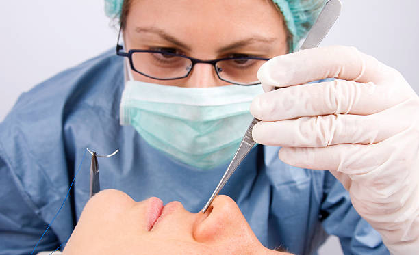 Doctor performing plastic surgery stock photo