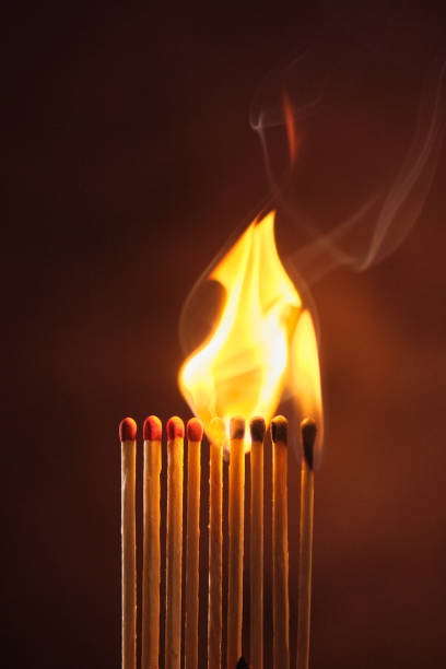 istock a row of matches are lit on a dark background 1849601091