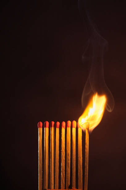 istock a row of matches are lit on a dark background 1849601095