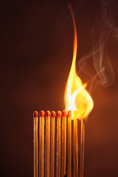 istock a row of matches are lit on a dark background 1849601606