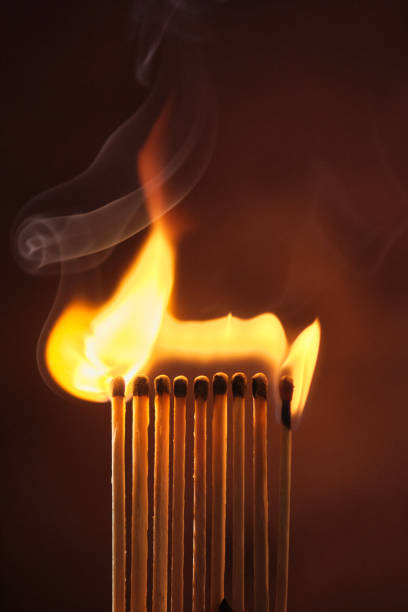 istock a row of matches are lit on a dark background 1849601612
