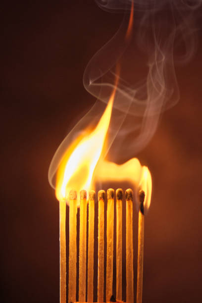 istock a row of matches are lit on a dark background 1849601725