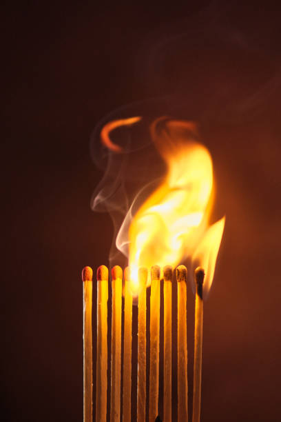 istock a row of matches are lit on a dark background 1849602649
