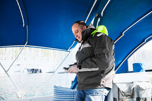 istock Sailing crew member on phone 184961035