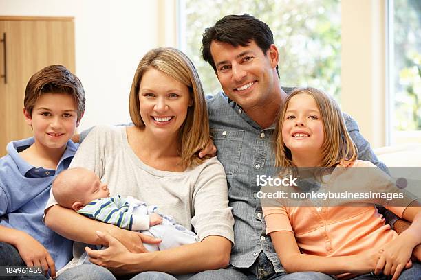 Family At Home With New Baby Stock Photo - Download Image Now - 30-39 Years, 6-7 Years, 8-9 Years