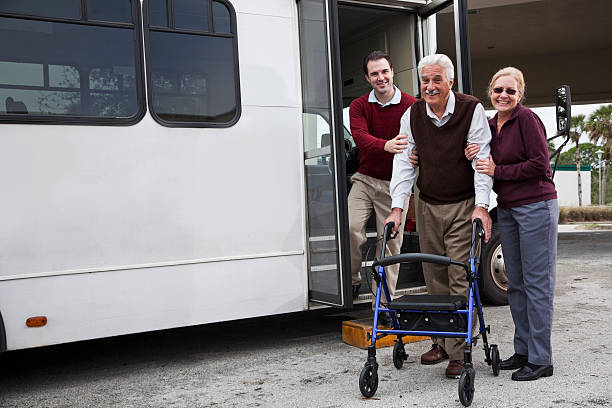 istock Man helping senior couple outside shuttle bus 184961460
