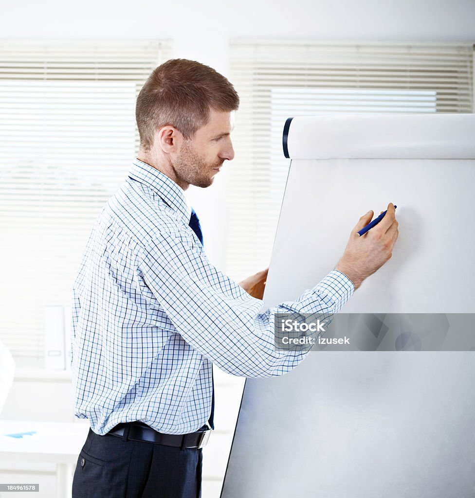 Presentation Businessman during a meeting, giving presentation on white board. 30-34 Years Stock Photo