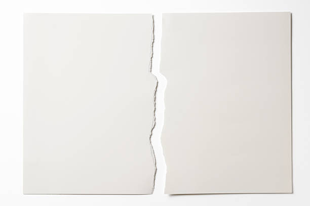 isolated shot of torn white paper on white background - tears stockfoto's en -beelden