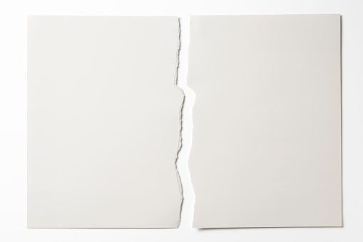 Close-up of blank torn piece of white paper isolated on white background with clipping path.