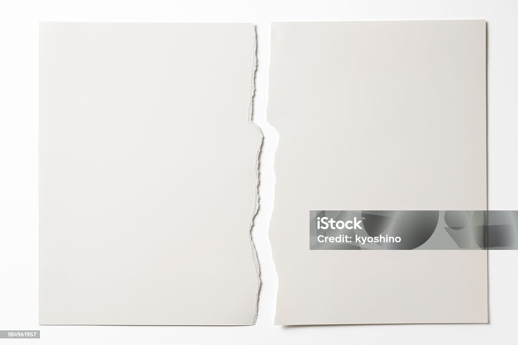 Isolated shot of torn white paper on white background Close-up of blank torn piece of white paper isolated on white background with clipping path. Paper Stock Photo
