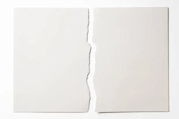 Photo of Isolated shot of torn white paper on white background
